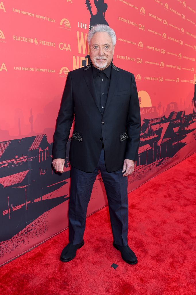 Tom Jones in black on red carpet