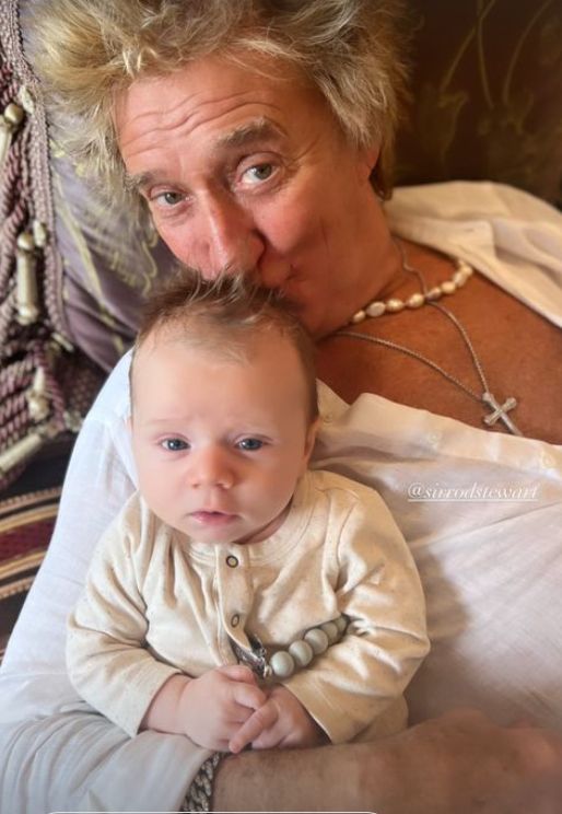 Rod Stewart kissing a baby boy