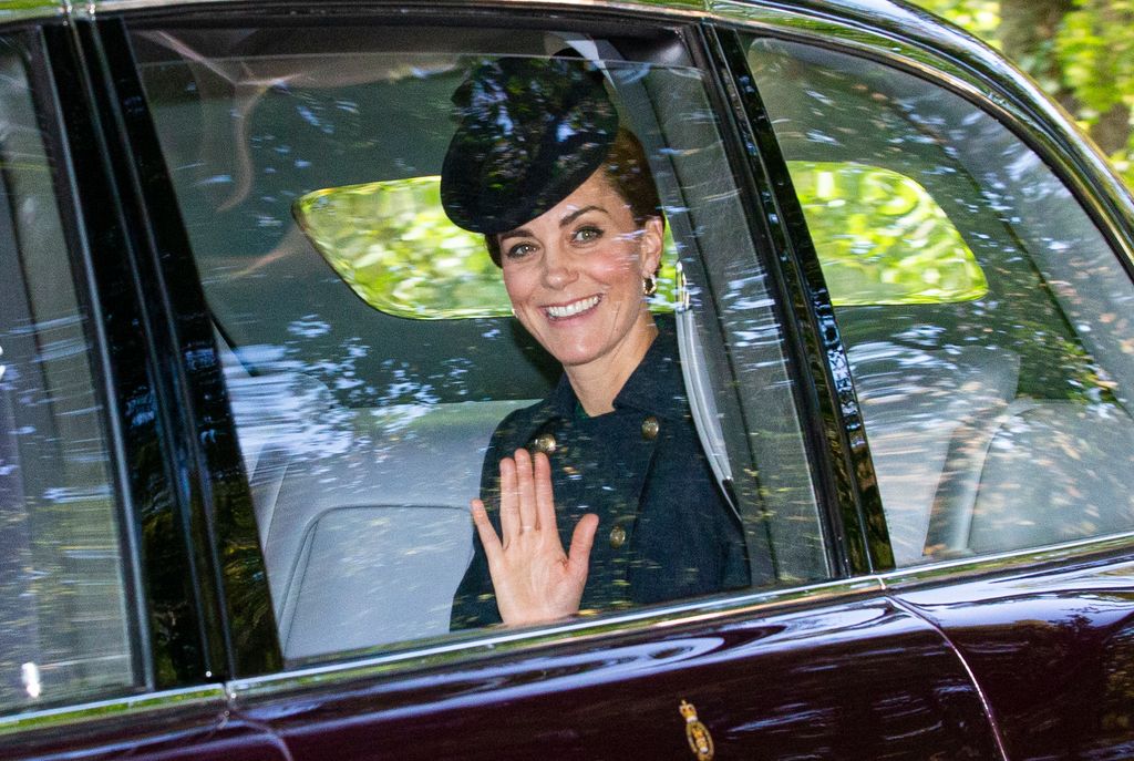 Catherine, then-Duchess of Cambridge waves while she is driven to Crathie Kirk Church before the service on August 25, 2019 in Crathie, Aberdeenshire.
