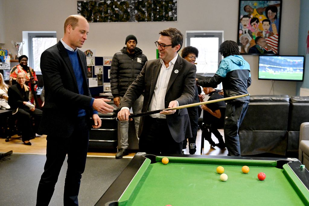 Prince William and Andy Burnham in front of a pool table