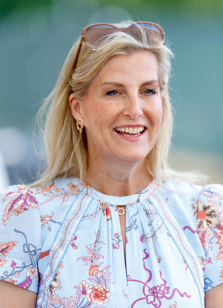Sophie, Duchess of Edinburgh grinning in blue printed dress