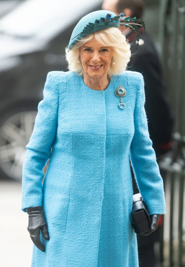 Queen Camilla wearing turquoise coat and hat 