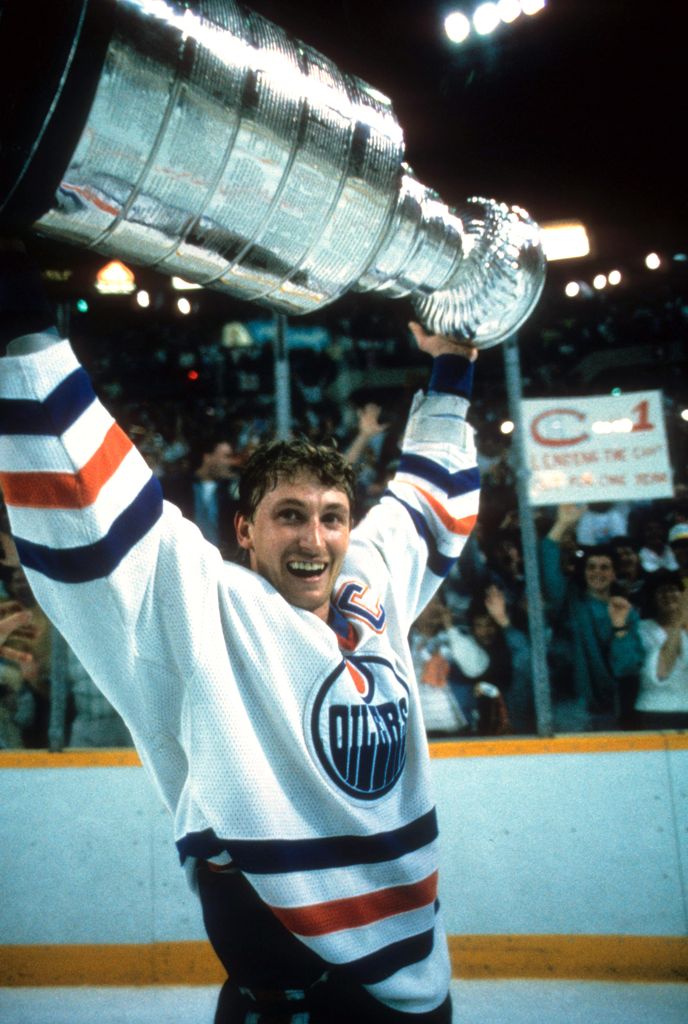Wayne Gretzky #99 of the Edmonton Oilers recieves the Stanley Cup Trophy after the Oilers defeated the Philadelphia Flyers in Game 7 of the 1987 Stanley Cup Finals on May 31, 1987 at the Northlands Coliseum in Edmonton, Alberta, Canada.