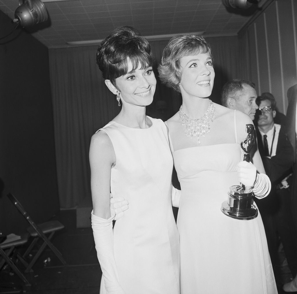 Julie Andrews was passed over, in favor of Audrey Hepburn, for the role of Eliza Dolittle in My Fair Lady, which she originated on stage. This freed her to play the title role in Mary Poppins, for which she won the Academy Award for Best Actress; Hepburn was not even nominated. Here the two of them stand after Andrews received her Oscar. 1965