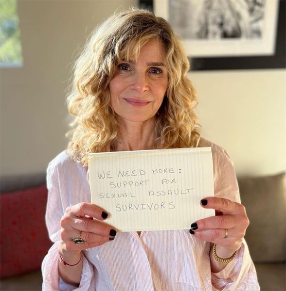 Kyra Sedgwick holding up a piece of paper