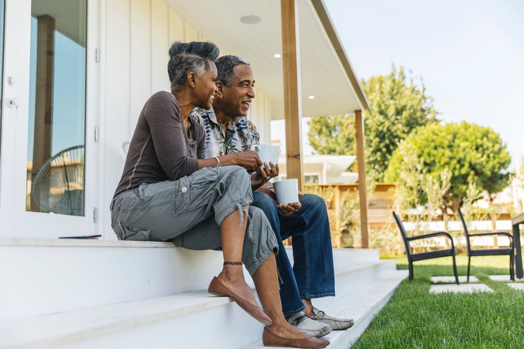 Mature couple drinking coffee on porch