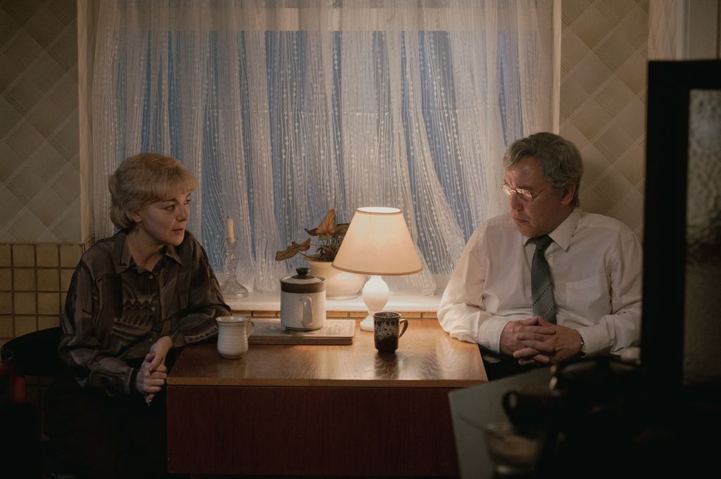 A couple sits across each other at a table