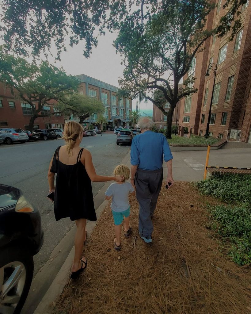 Francesca Eastwood, her son Titan, and Clint Eastwood walking 