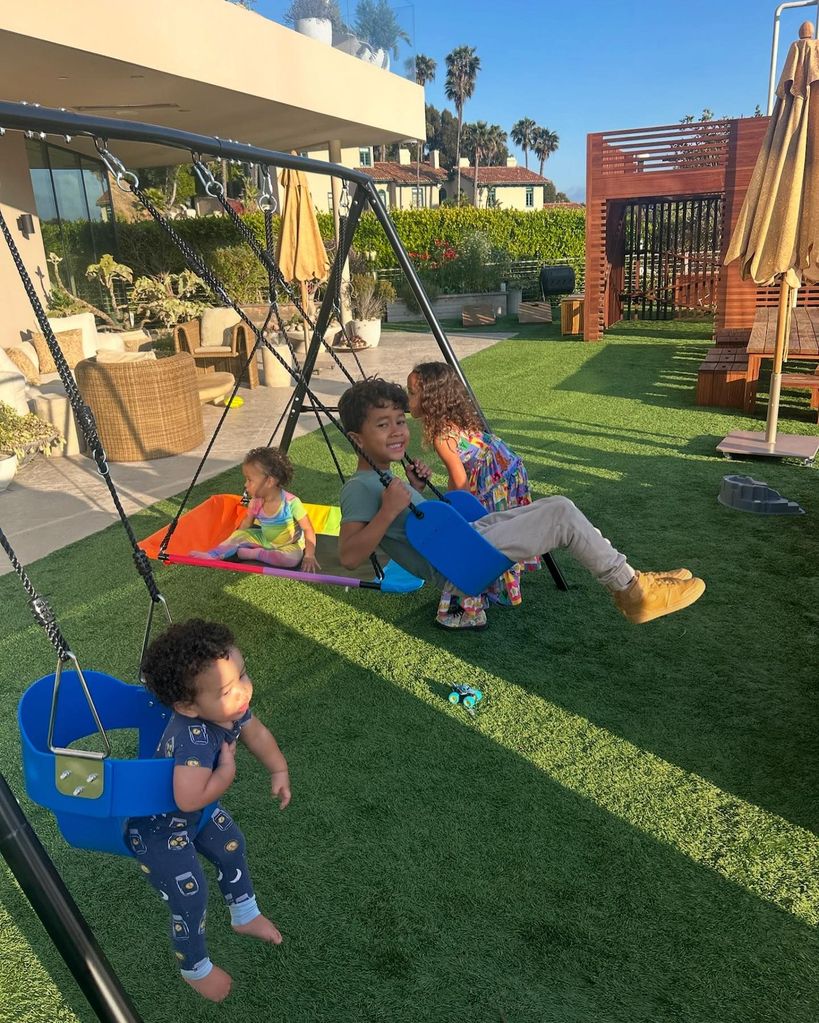 Chrissy Teigen and John Legend's four children playing on swings at home 