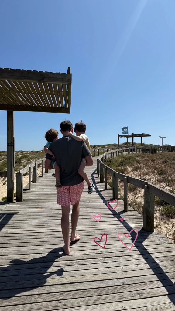 Jack Brooksbank carrying sons August and Ernest to the beach