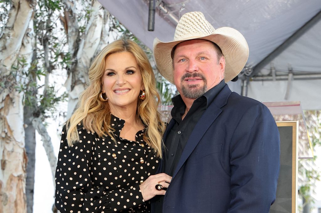 US country singer Trisha Yearwood (L) and husband US country singer Garth Brooks pose during her Hollywood Walk of Fame Star Ceremony in front of Capitol Records 