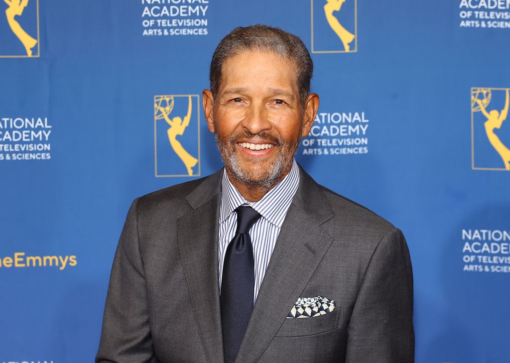 bryant gumbel smiling in gray suit