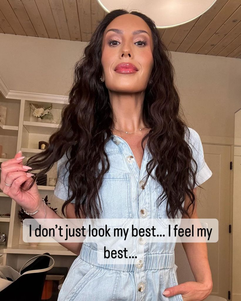 cheryl burke with long hair in denim jumpsuit