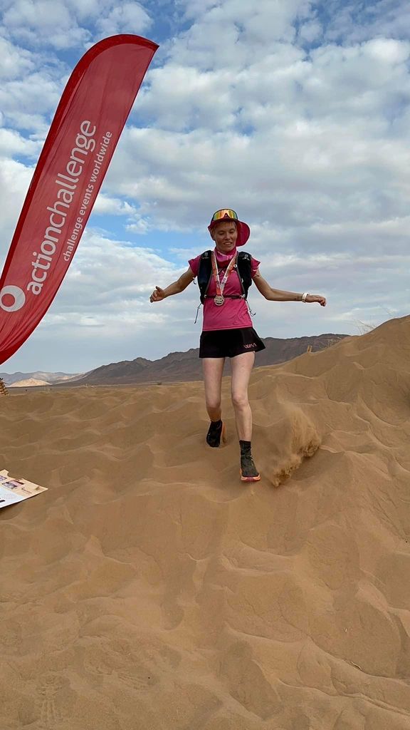 Woman running in the Sahara Desert