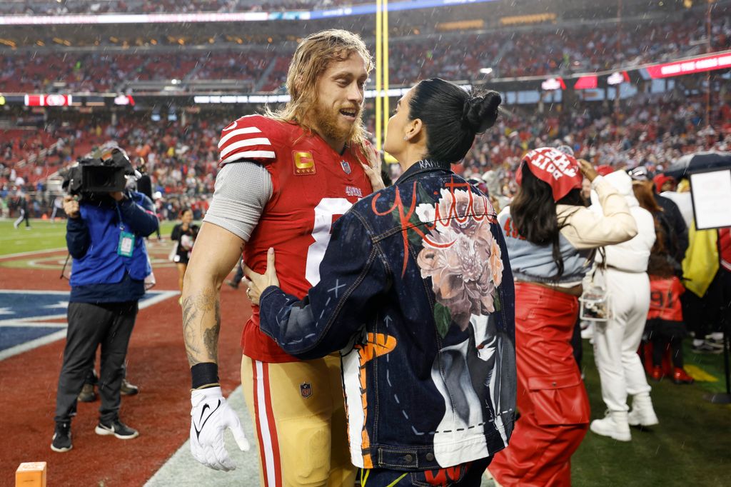 George Kittle #85 of the San Francisco 49ers stands with his wife Claire Kittle before the NFC Divisional Playoffs against the Green Bay Packers at Levi's Stadium on January 20, 2024 in Santa Clara, California.
