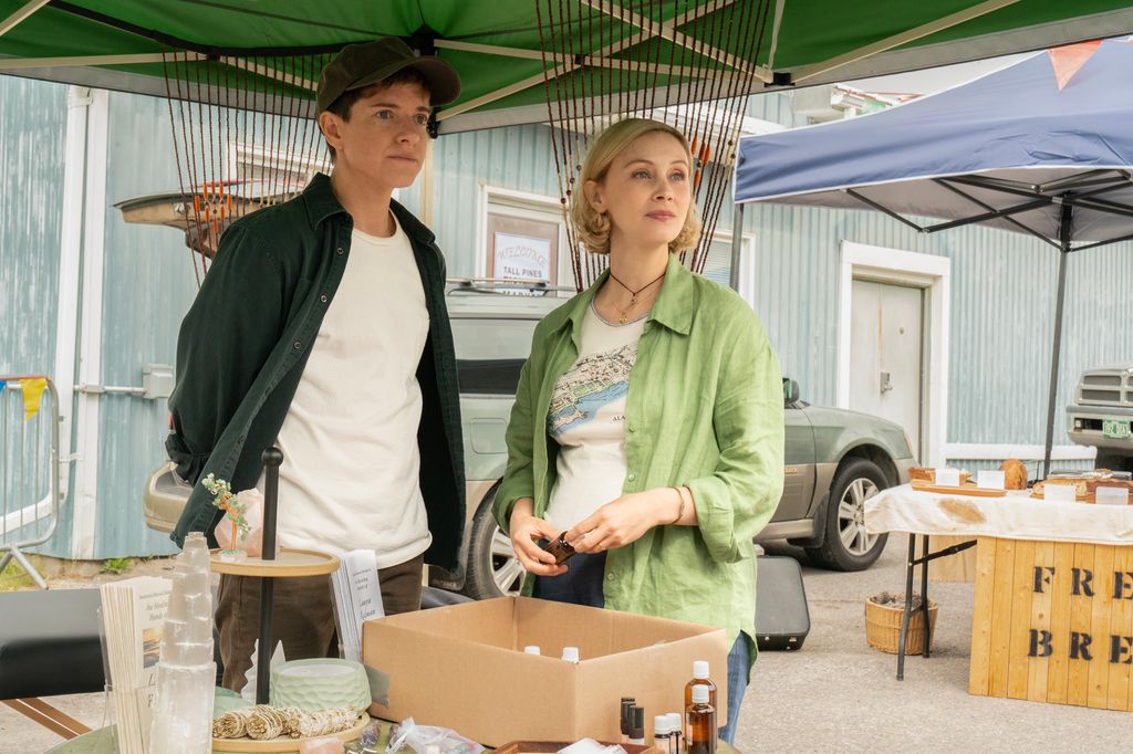 two people standing by table outdoors