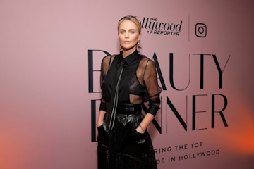 Charlize Theron Embraces Vampy Glam in Sheer Blouse With Leather Skirt -  Parade