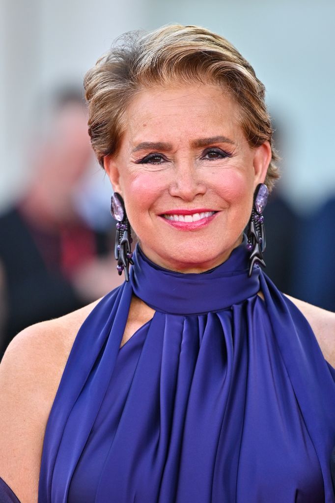 woman posing on red carpet in purple dress