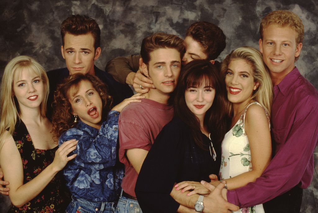 The Beverly Hills, 90210 cast poses for a portrait on set, September 1991 in Los Angeles, California. Left to right: Jennie Garth, Gabrielle Carteris, Luke Perry, Jason Priestley, Brian Austin Green, Shannen Doherty, Tori Spelling and Ian Ziering. 
