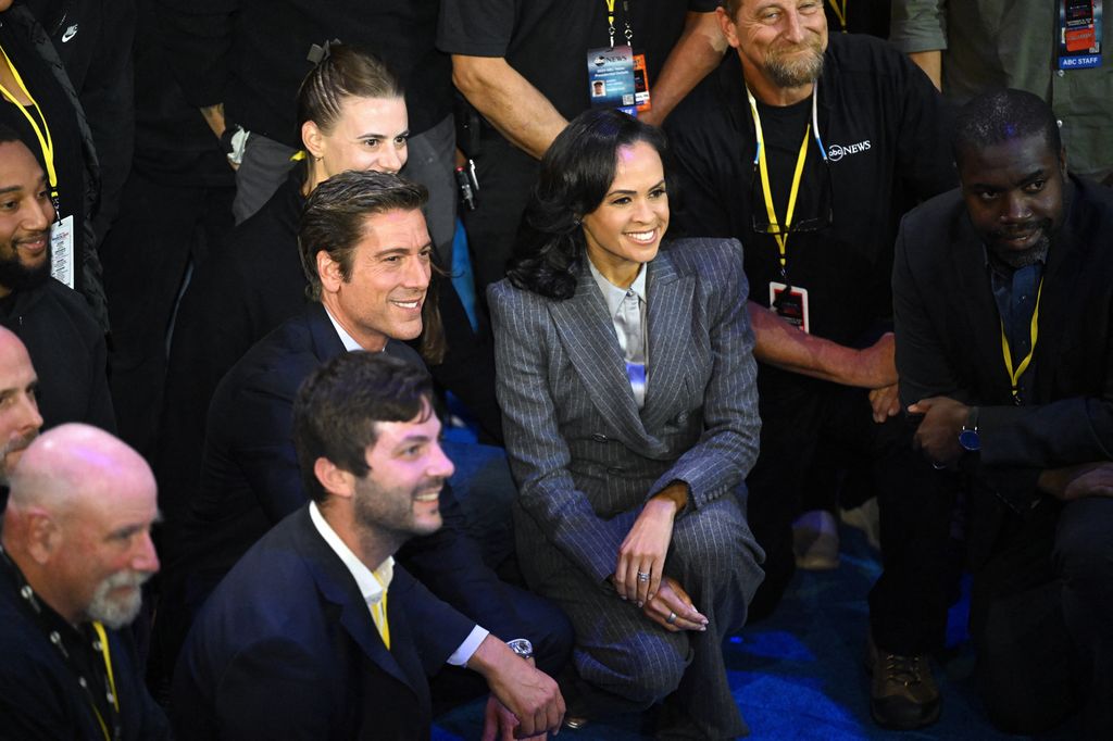 US broadcaster David Muir (L) and US broadcaster Linsey Davis (R) pose for pictures with ABC News crew members at the end of a presidential debate with US Vice President and Democratic presidential candidate Kamala Harris and former US President and Republican presidential candidate Donald Trump at the National Constitution Center in Philadelphia, Pennsylvania, on September 10, 2024