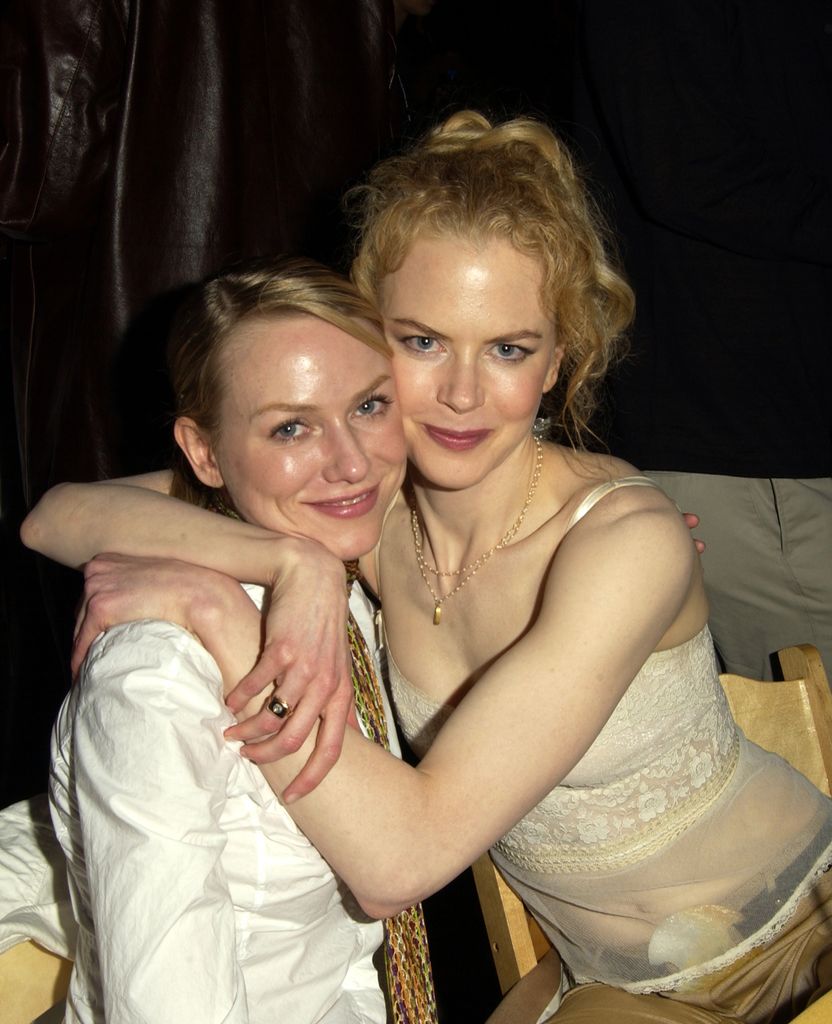 Naomi Watts in white blazer and Nicole Kidman in sheer nude corset hugging in 2002.