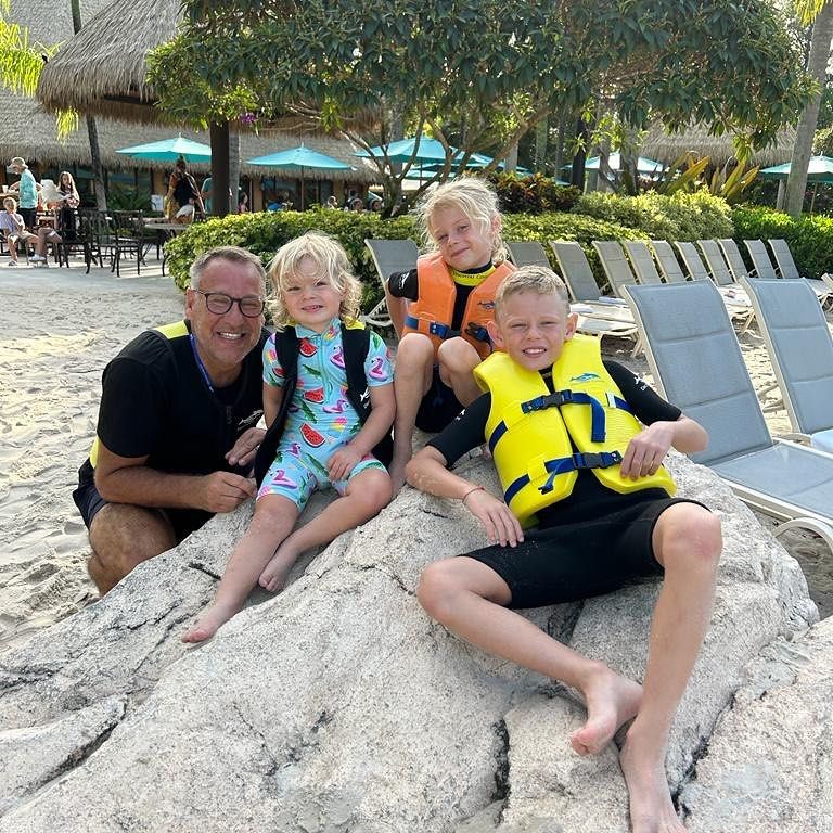 Paul merson with his three children at beach