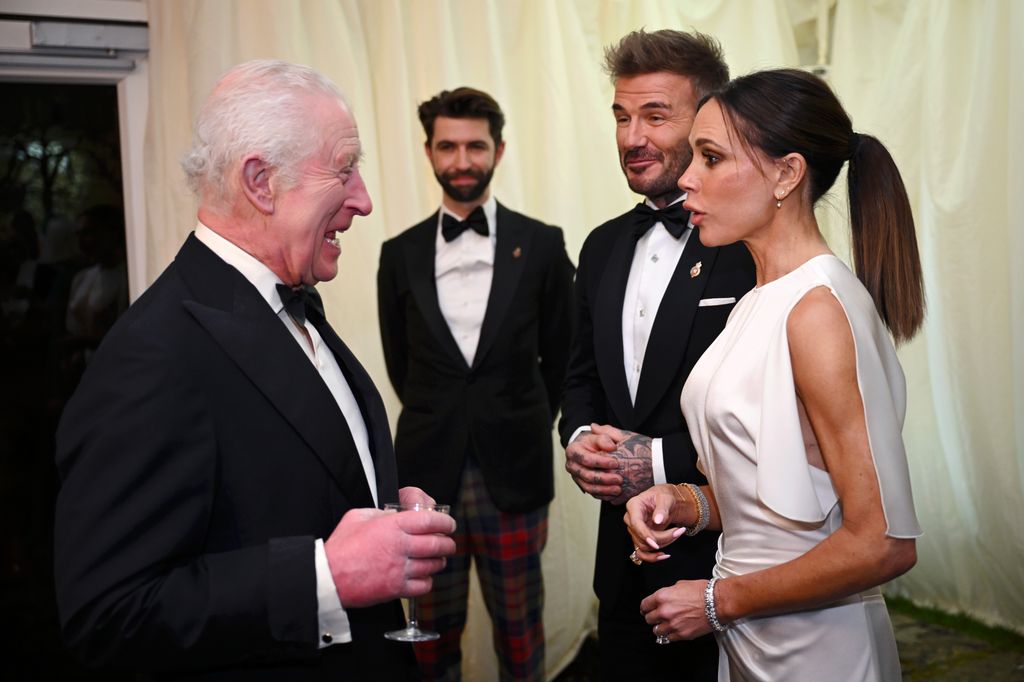 King Charles speaking to David and Victoria Beckham