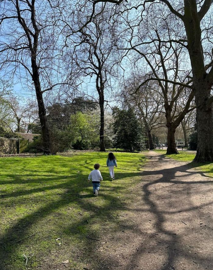 Two children running in a park