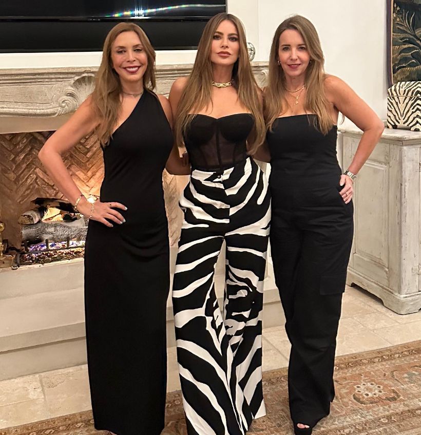 Sofia Vergara in sheer corset and zebra-print pants with two friends