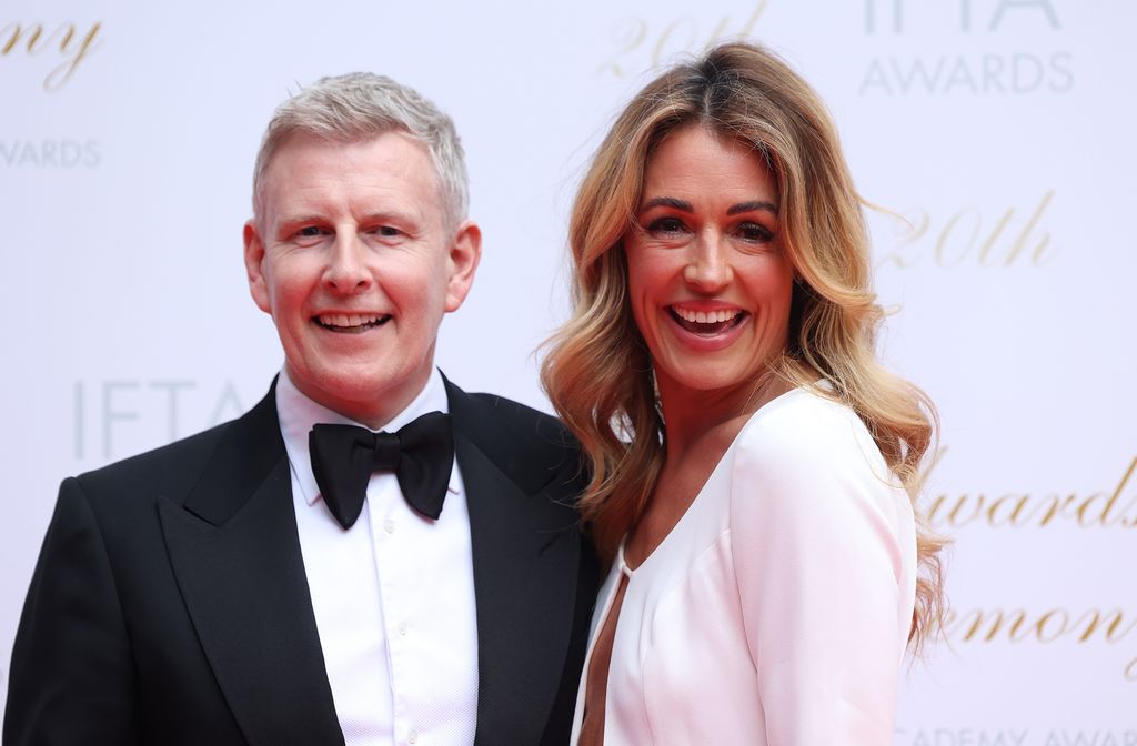 patrick kielty in tux and bow tie posing with wife cat deeley
