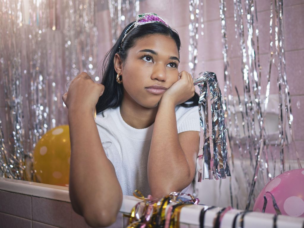 Girl in bath thinking during party with bored, tired or frustrated expression on face.