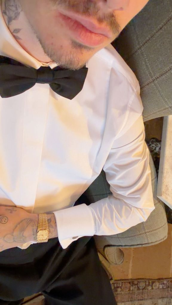 A photo of a man in a white shirt and bow tie