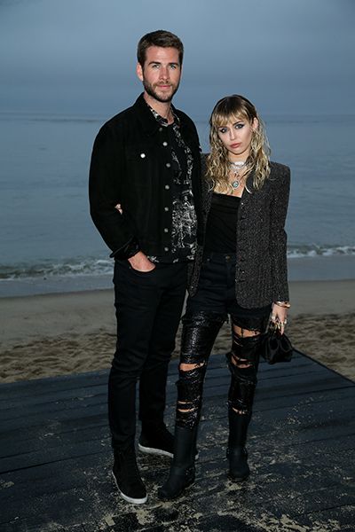 miley cyrus liam hemsworth posing on the beach