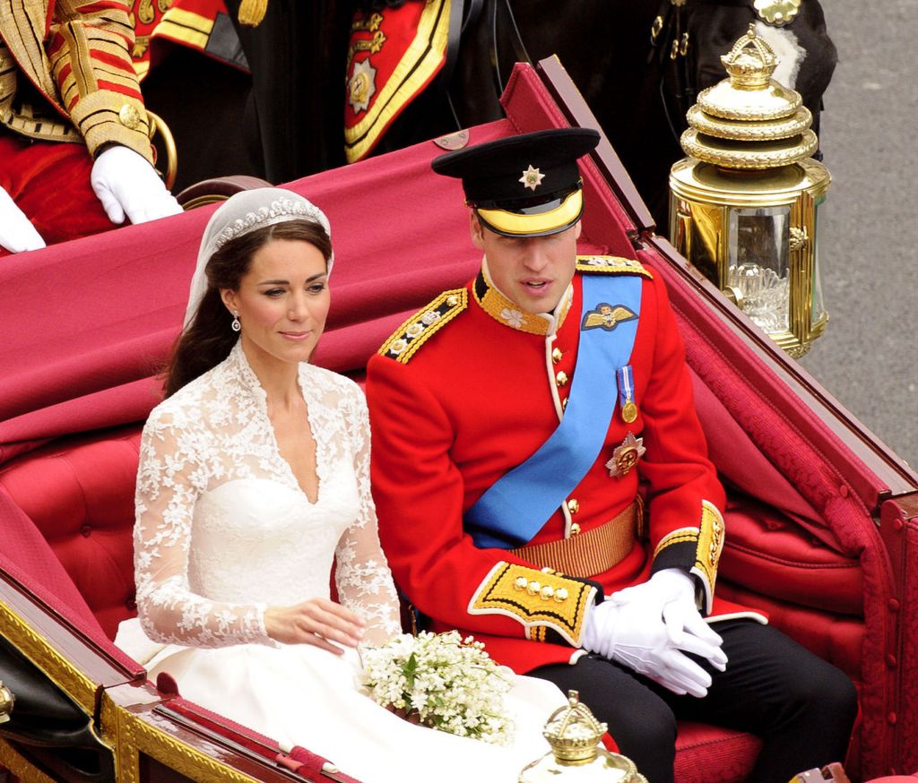 Kate Middleton and Prince William talking in their wedding carriage
