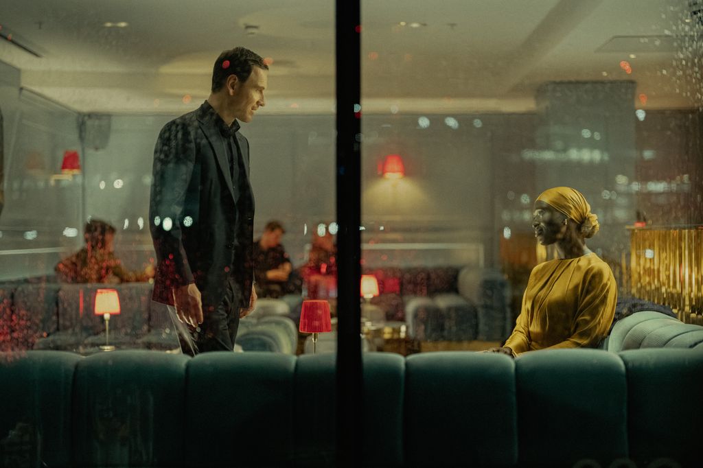 Michael Fassbender as Martian and Jodie Turner Smith as Samia Zahir in The Agency