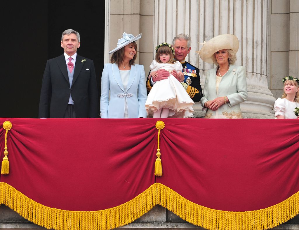 royals greeting crowds from the balcony of Buckingham Palace
