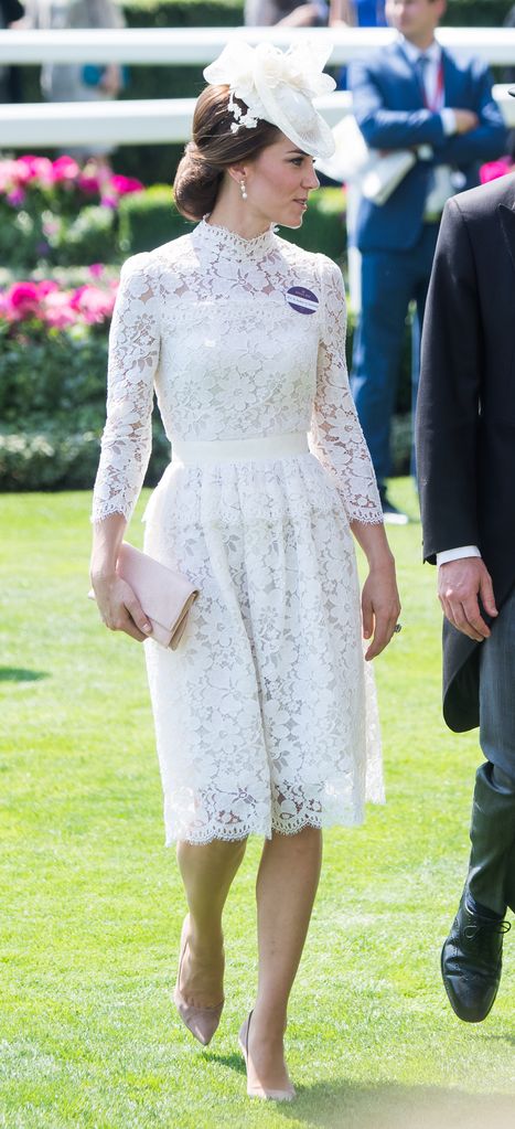 Kate in white dress featuring a lacy neckline and sleeves