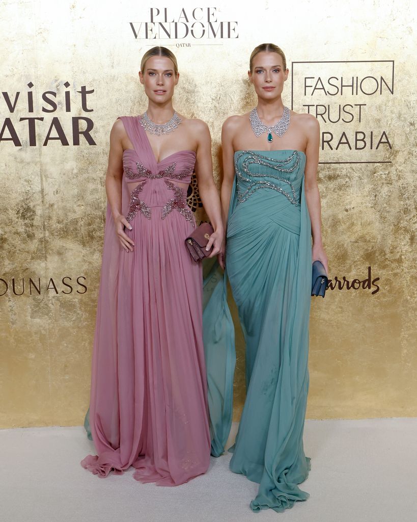 Lady Amelia Spencer in pink gown and Lady Eliza Spencer in teal gown with gold backdrop