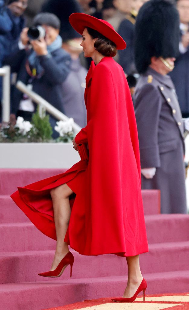 Princess Kate in red walking up steps