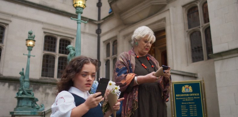 Two people outside the register office who view the phones