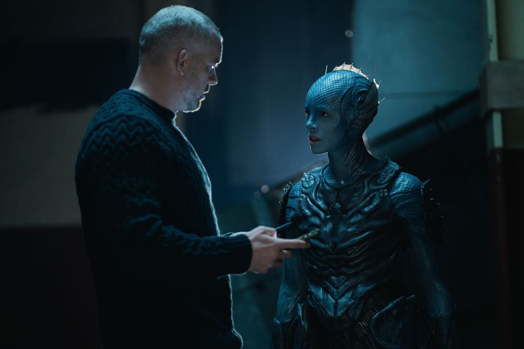 man and creature standing opposite one another