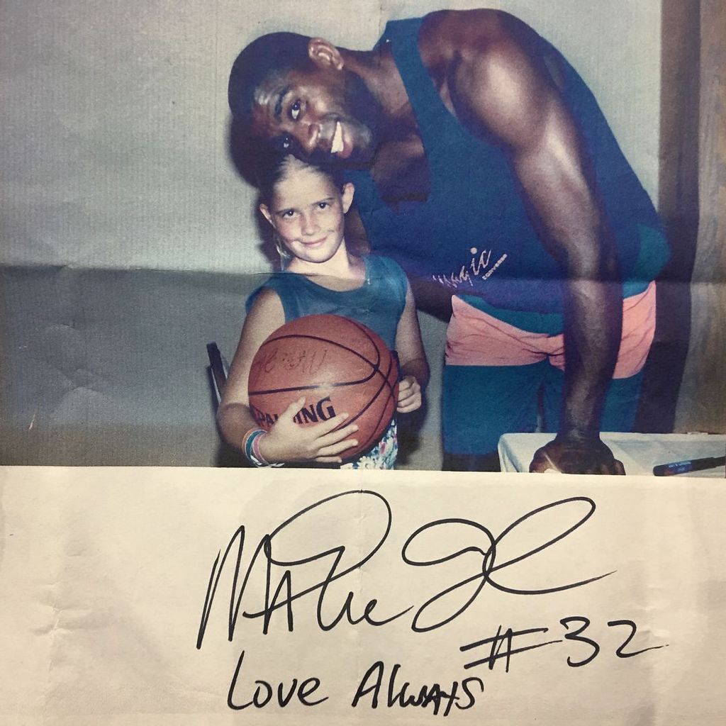 Christina Hall poses with Magic Johnson as a young girl