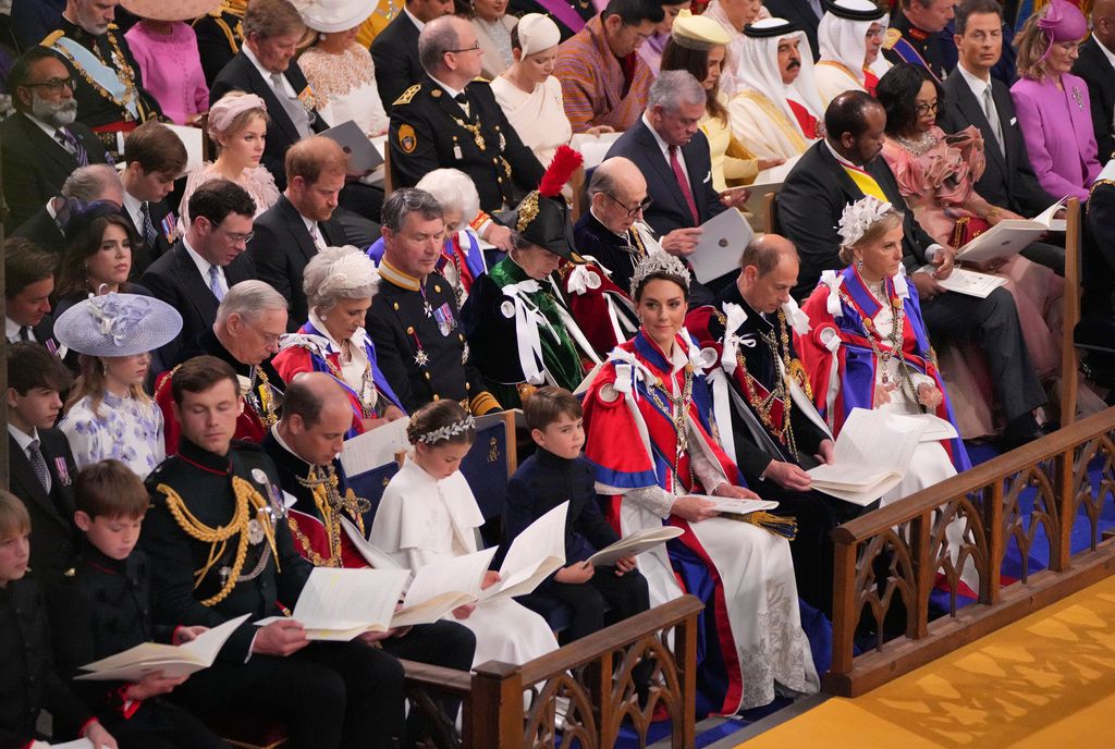 royal family members sit in seats of Westminster Abbey for coronation service