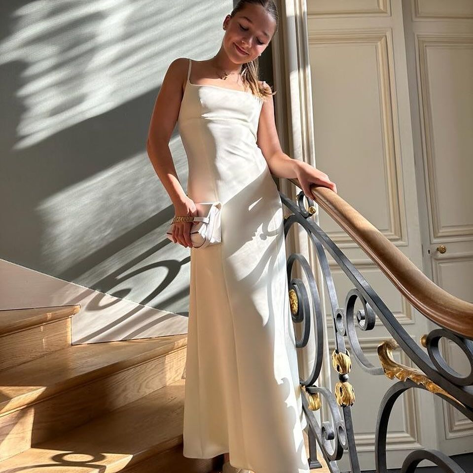 Harper Beckham wears an ivory dress