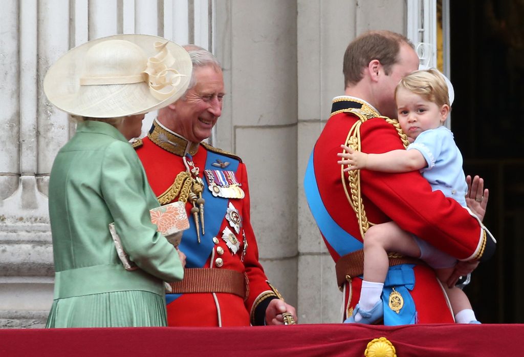 Camilla and Charles look at Prince George as they stand on the balcony of Buckingham Palace during the annual Trooping The Colour ceremony at Horse Guards Parade in 2015