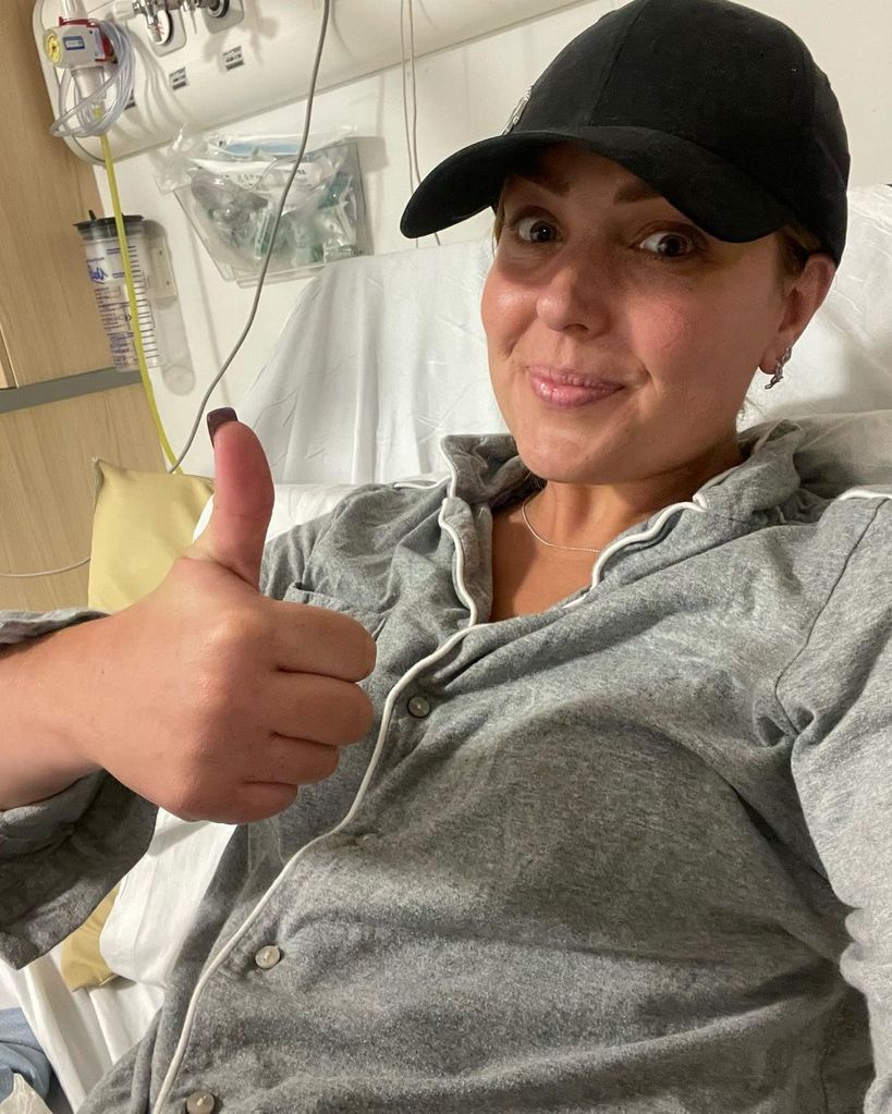 Amy Dowden smiling from hospital bed 