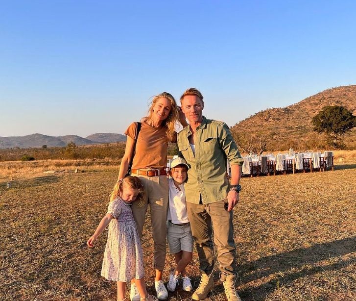 Ronan and Storm Keating stood on African plains with their two children