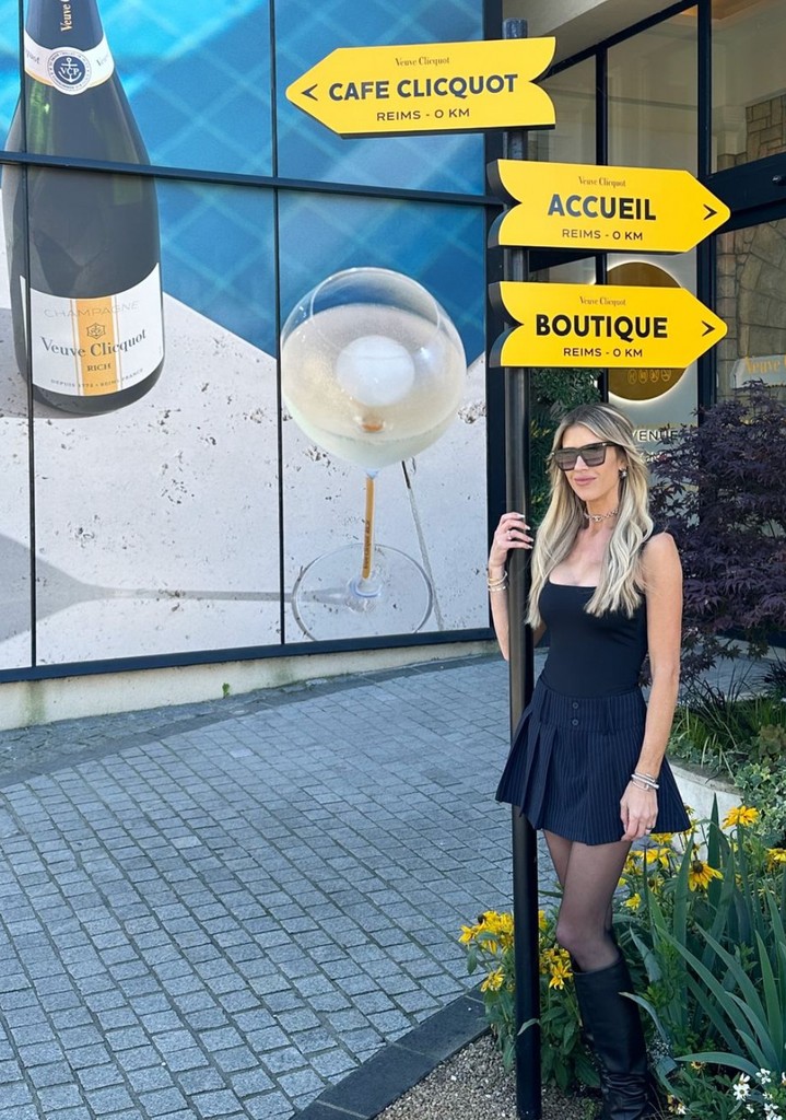 Photo shared by Christina Hall on Instagram October 2024 of herself at the Veuve Clicquot headquarters in Reims during a trip to Pairs, France