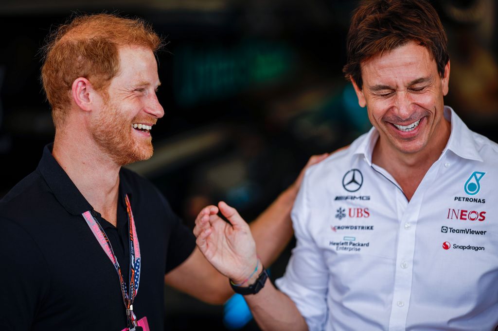 Prince Harry, Duke of Sussex laughs with Mercedes GP Executive Director Toto Wolff in the garage prior to the F1 Grand Prix 