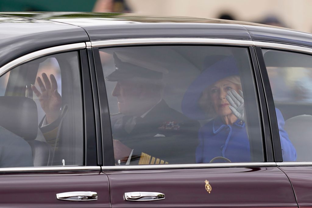 Charles and Camilla wave from car on VE Day